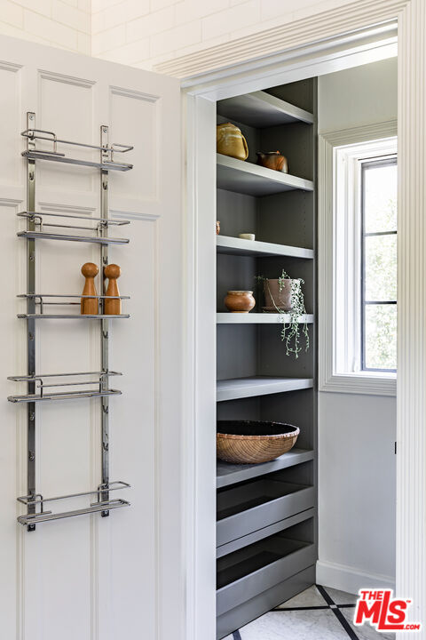3701 Shannon Road Los Angeles, CA 90027 - Photo 13 of 54 a view of storage and utility room with racks on the wall