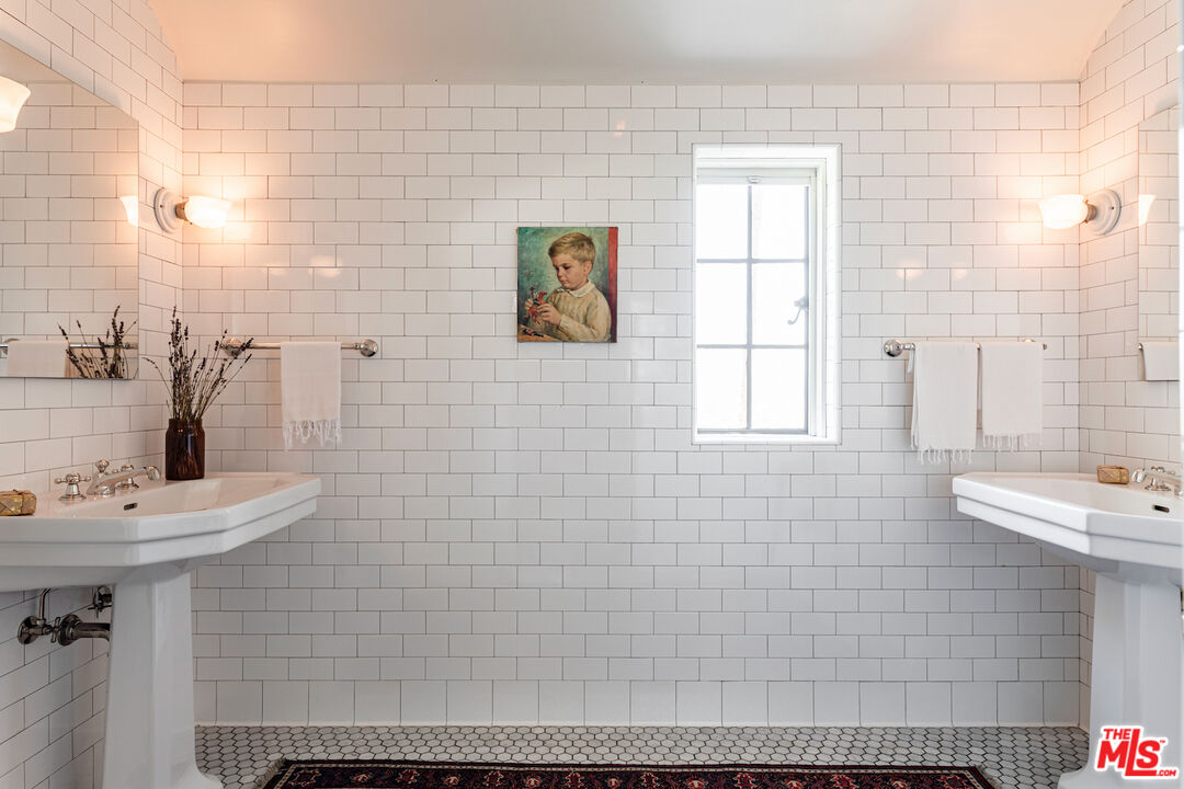 3701 Shannon Road Los Angeles, CA 90027 - Photo 21 of 54 a bathroom with a sink a mirror and shower