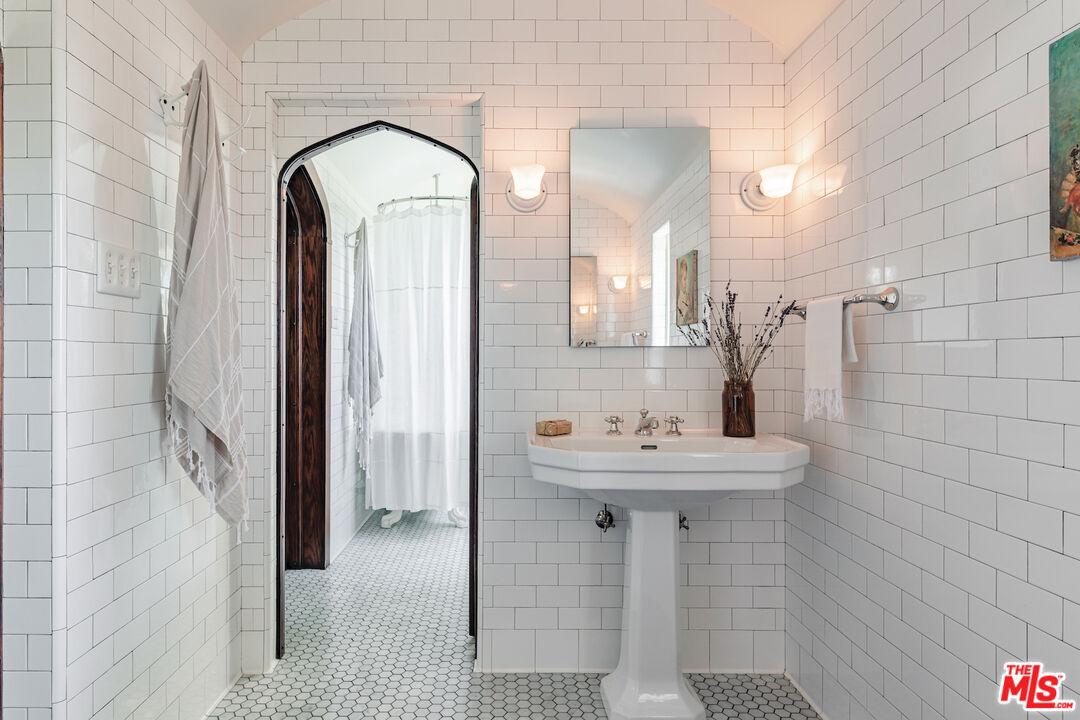 3701 Shannon Road Los Angeles, CA 90027 - Photo 22 of 54 a bathroom with a sink a mirror and a shower