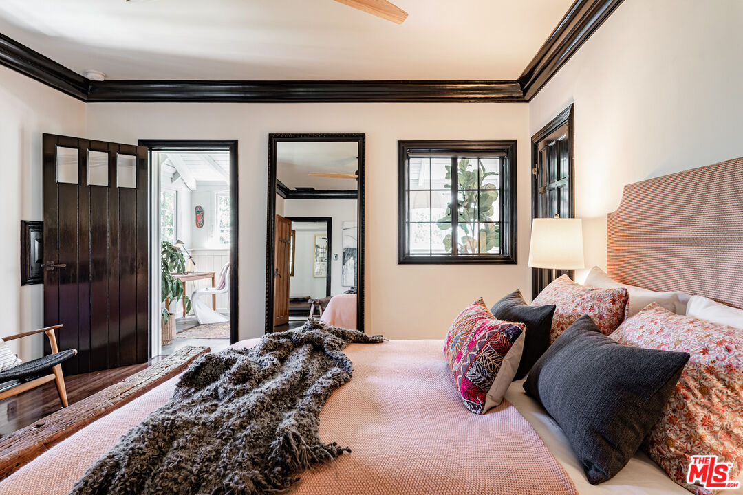 3701 Shannon Road Los Angeles, CA 90027 - Photo 25 of 54 a bedroom with a bed and glass windows