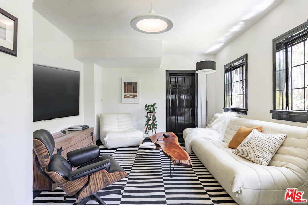 3701 Shannon Road Los Angeles, CA 90027 - Photo 39 of 54 a bedroom with furniture and a flat screen tv