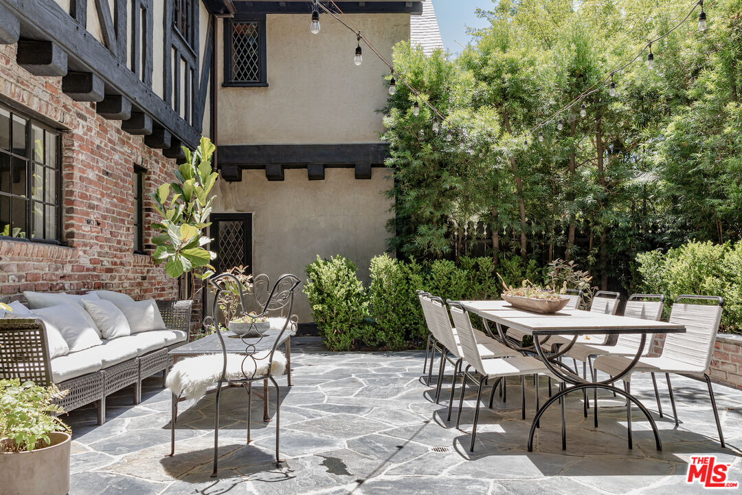 3701 Shannon Road Los Angeles, CA 90027 - Photo 43 of 54 a view of a patio with table and chairs and potted plants