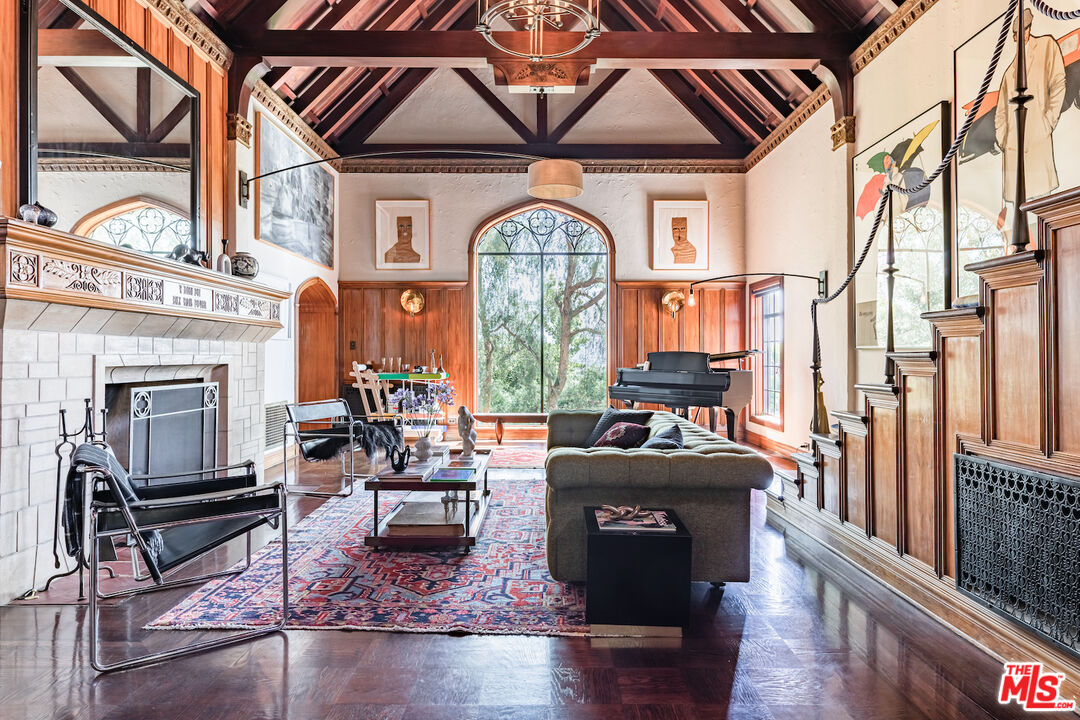 3701 Shannon Road Los Angeles, CA 90027 - Photo 6 of 54 a living room with furniture a fireplace and a chandelier