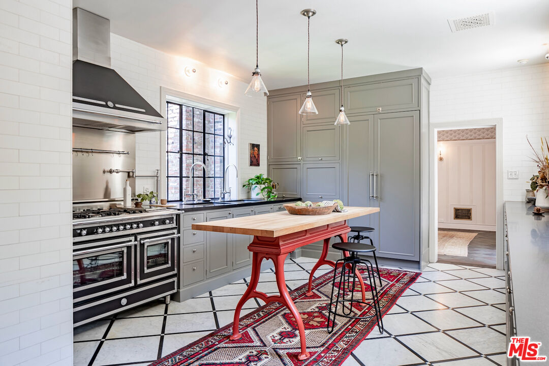 3701 Shannon Road Los Angeles, CA 90027 - Photo 10 of 54 a kitchen with stainless steel appliances kitchen island a table and chairs in it