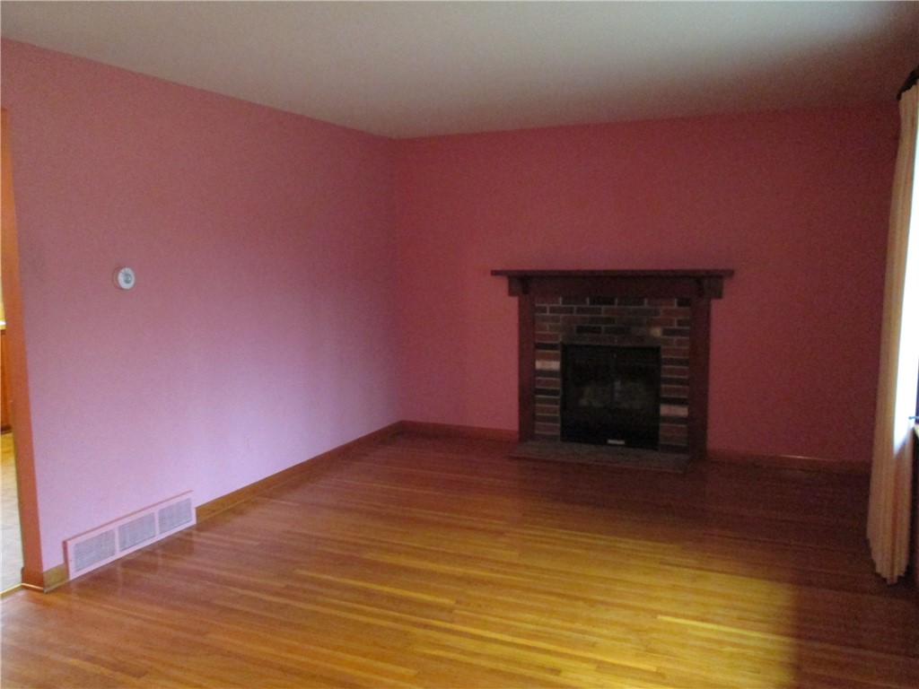 67 Browns Road Wheatland, NY 14546 - Photo 13 of 26 Living room with hardwood floors & gas fireplace