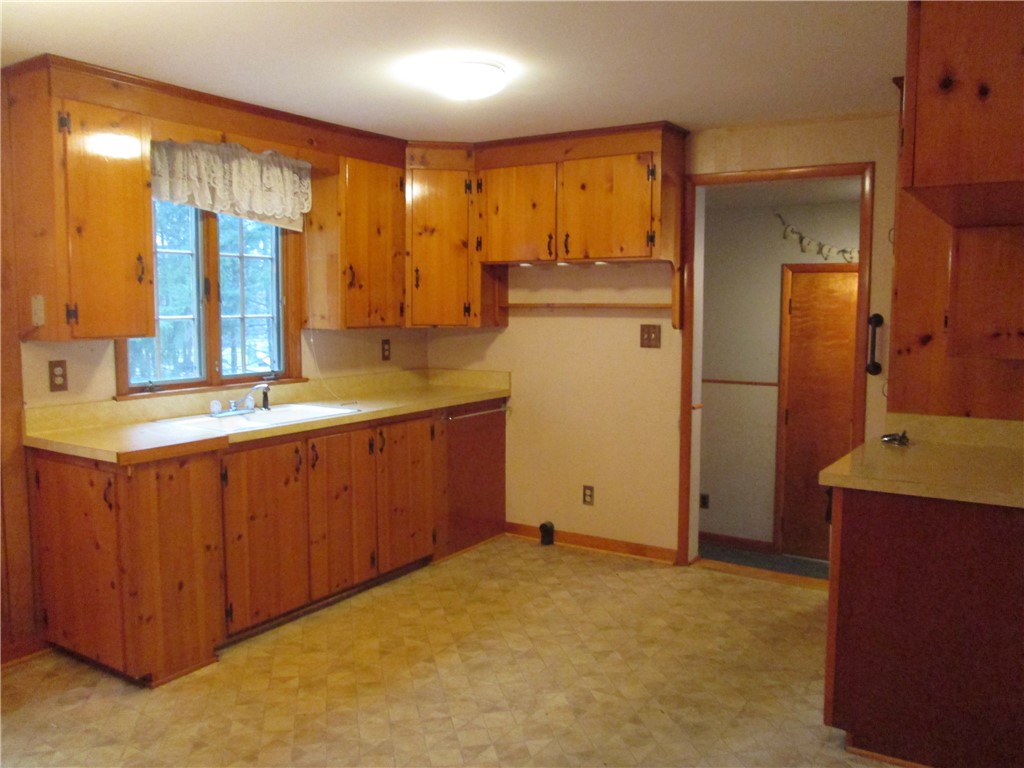 67 Browns Road Wheatland, NY 14546 - Photo 6 of 26 Knotty pine cabinets, vinyl flooring