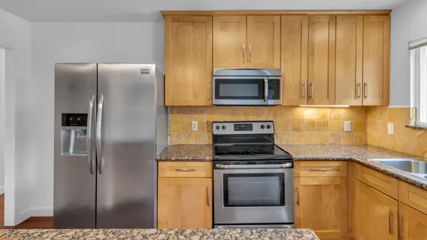 a kitchen with a stove microwave and refrigerator