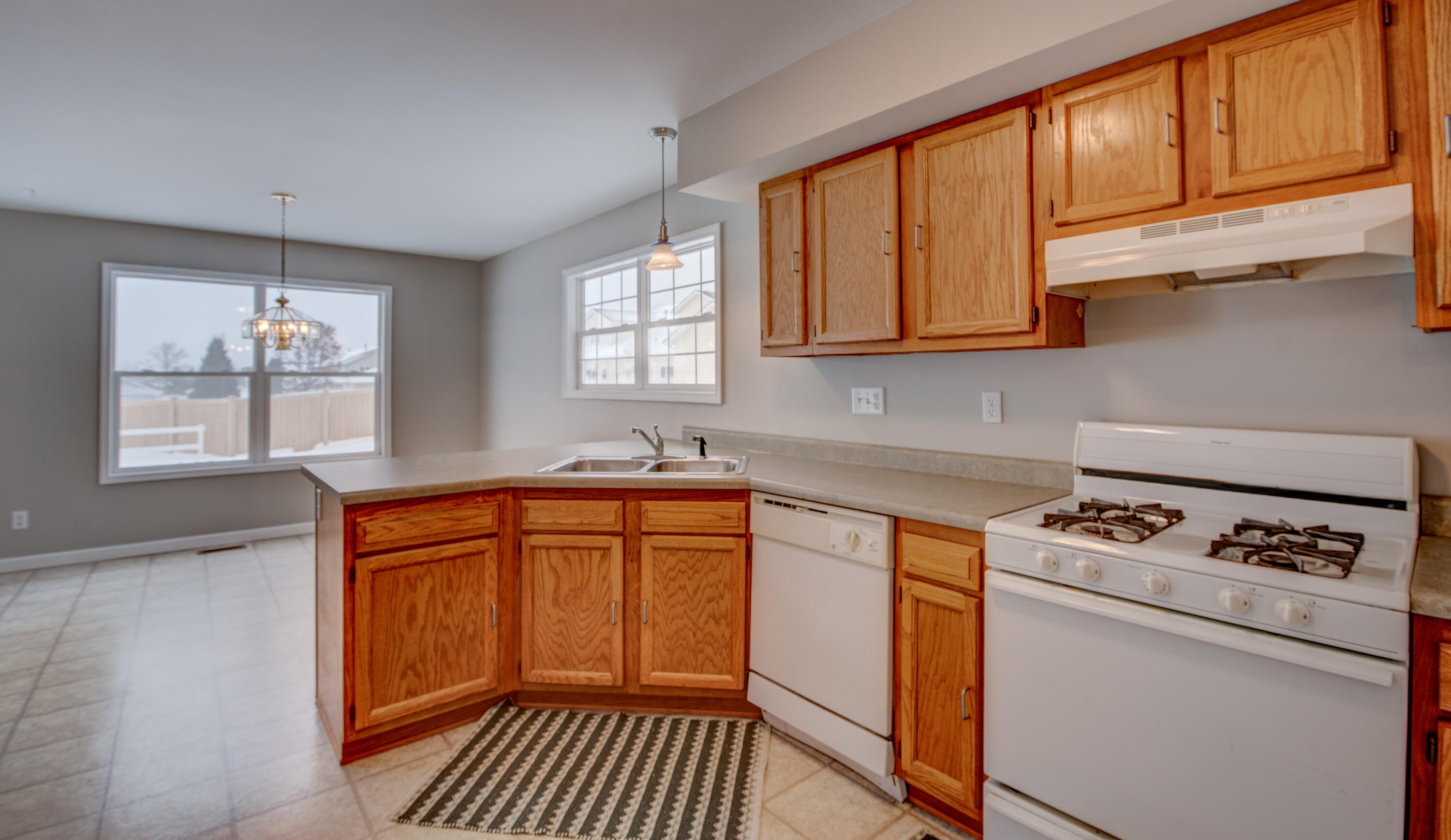 7736 East 108th Avenue, Unit C Crown Point, IN 46307 - Photo 12 of 28 a kitchen with granite countertop cabinets stainless steel appliances a sink and a window