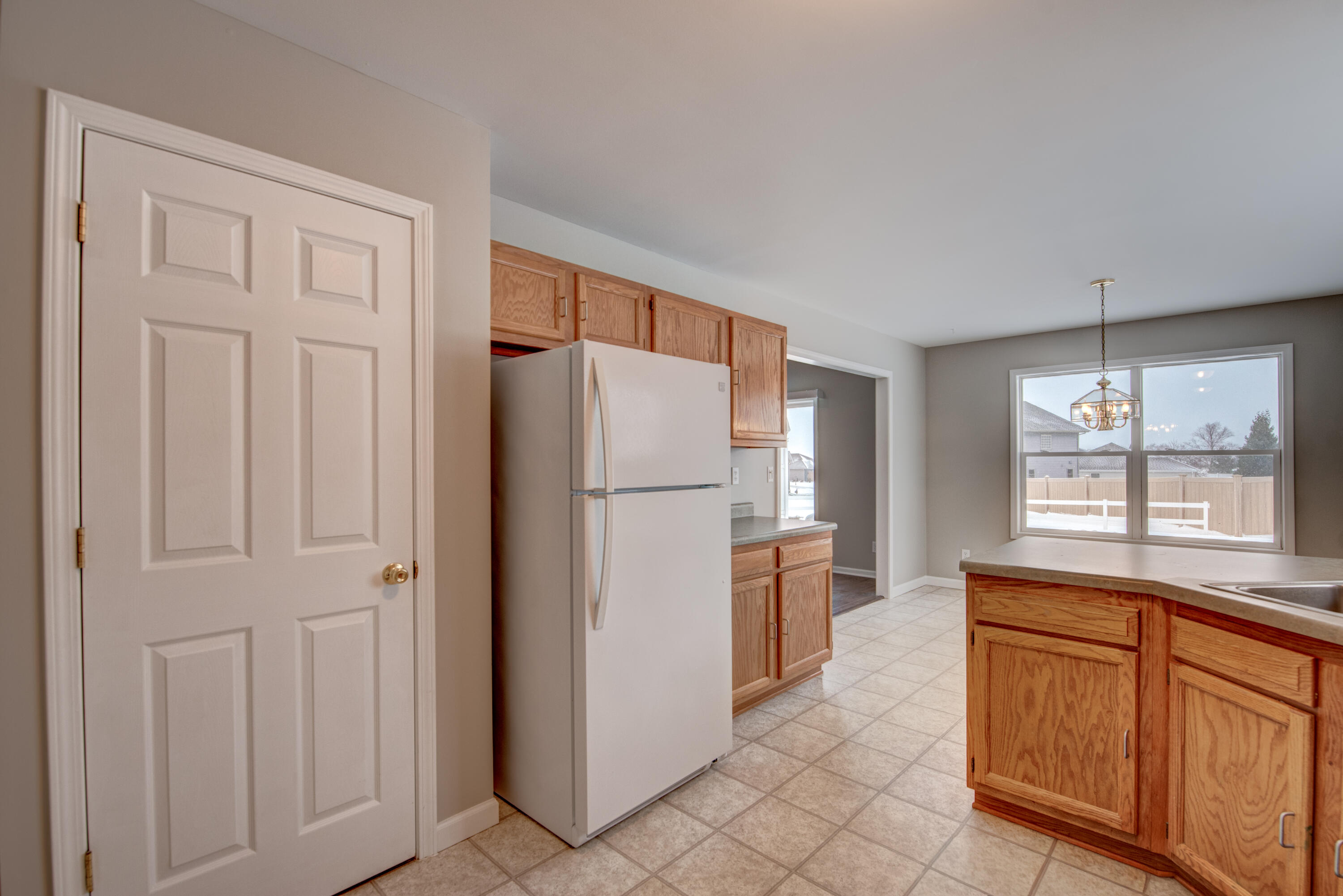 7736 East 108th Avenue, Unit C Crown Point, IN 46307 - Photo 15 of 28 a kitchen with stainless steel appliances granite countertop a refrigerator and a sink
