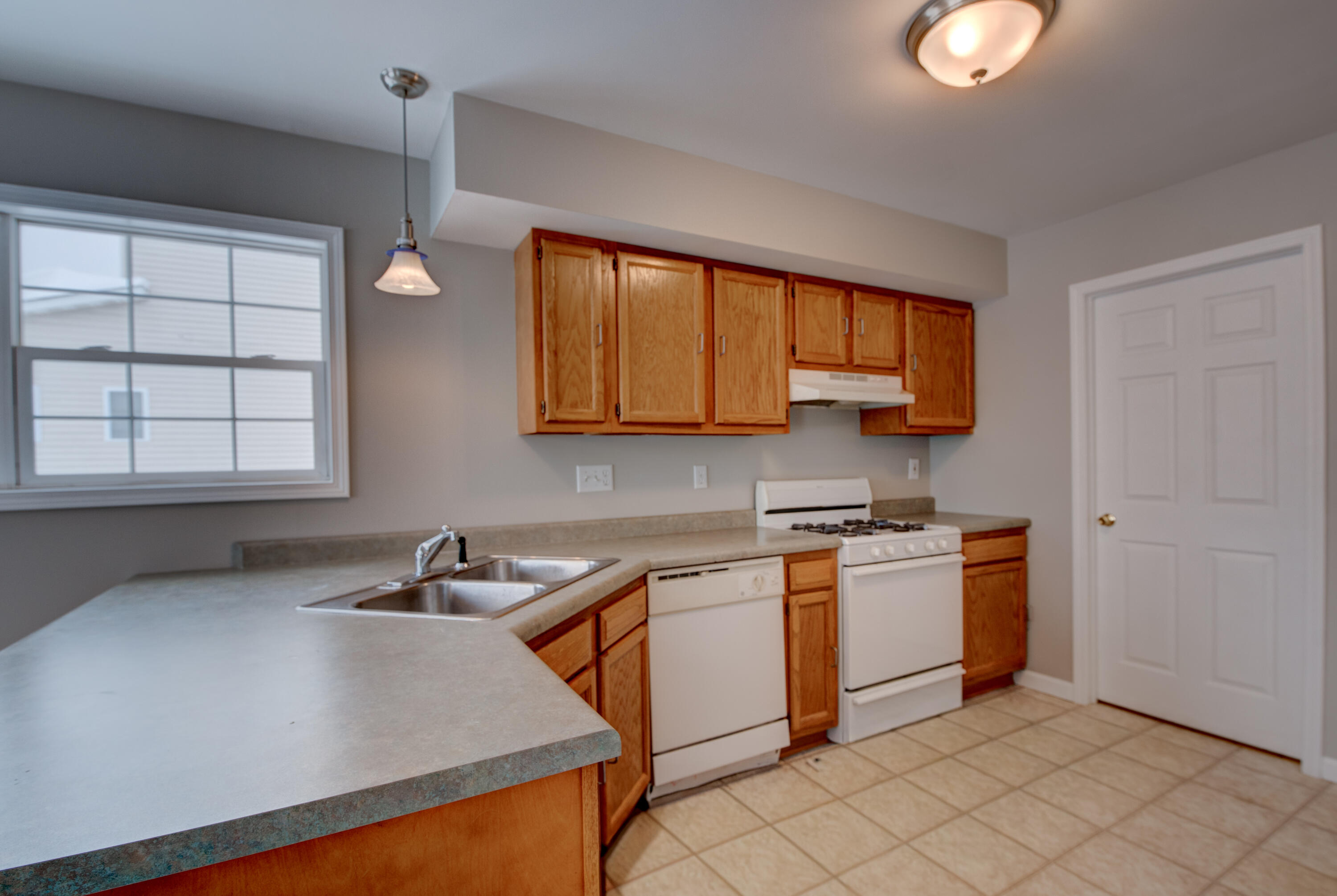 7736 East 108th Avenue, Unit C Crown Point, IN 46307 - Photo 16 of 28 a kitchen that has a sink and a stove