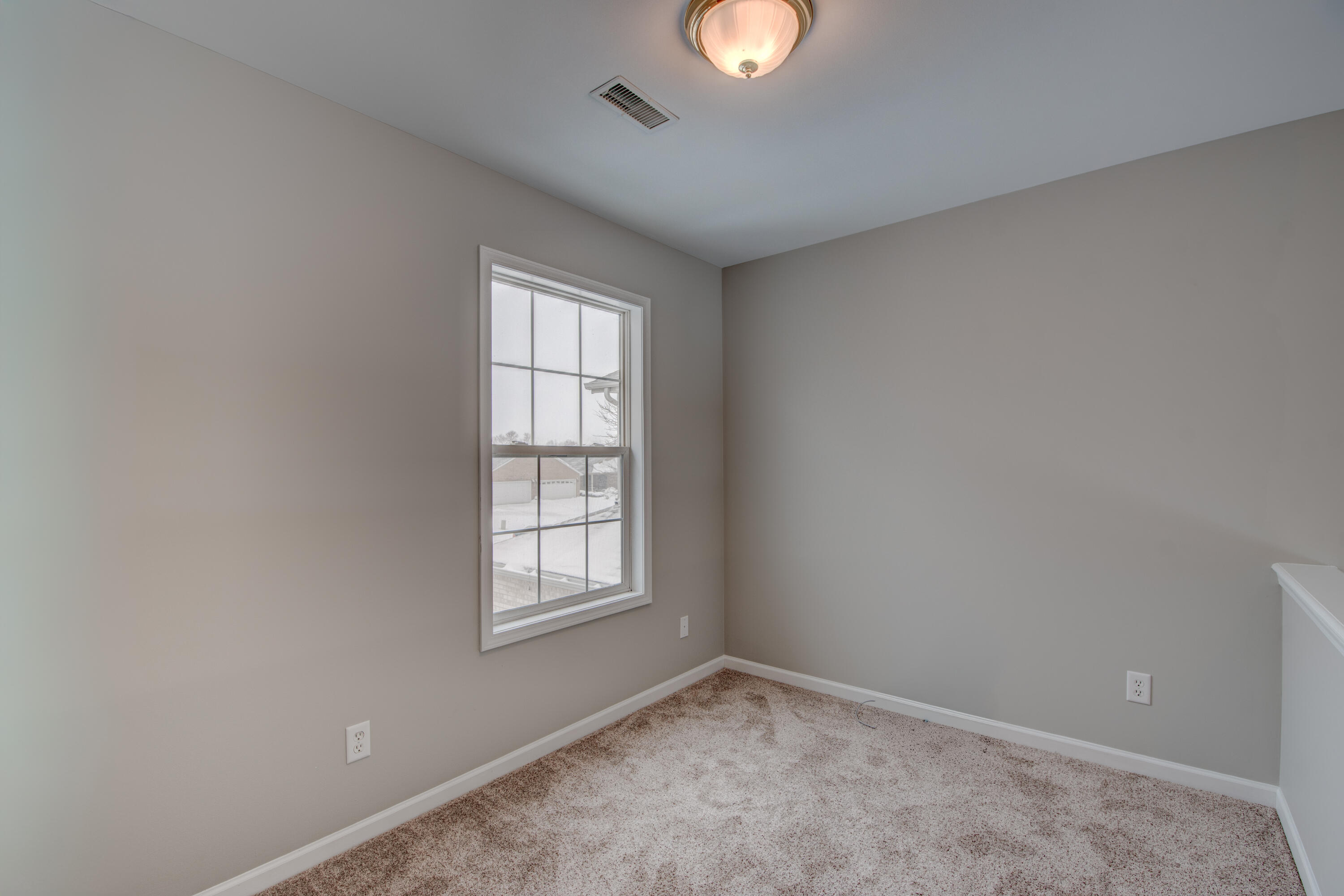 7736 East 108th Avenue, Unit C Crown Point, IN 46307 - Photo 21 of 28 an empty room with windows