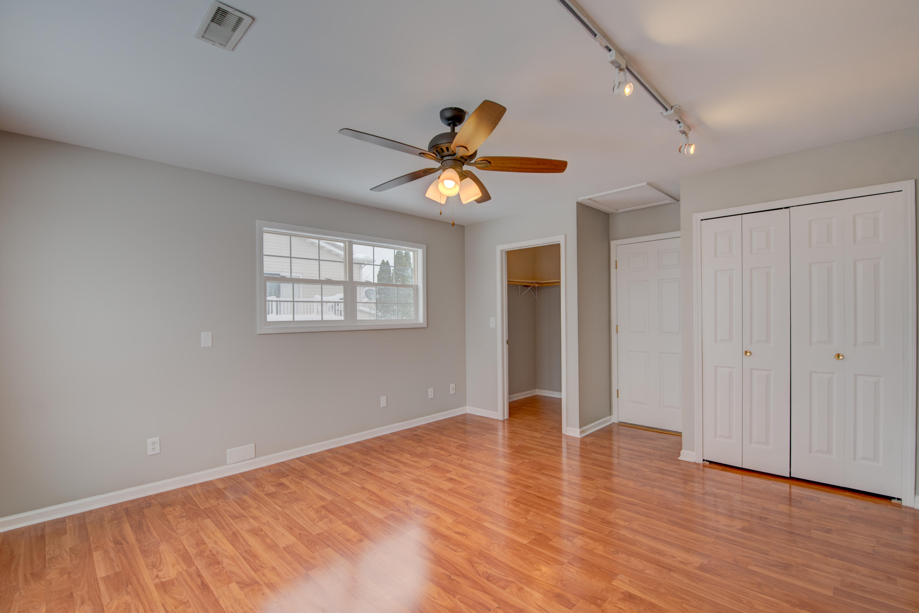 7736 East 108th Avenue, Unit C Crown Point, IN 46307 - Photo 23 of 28 a view of an empty room with window and a chandelier fan