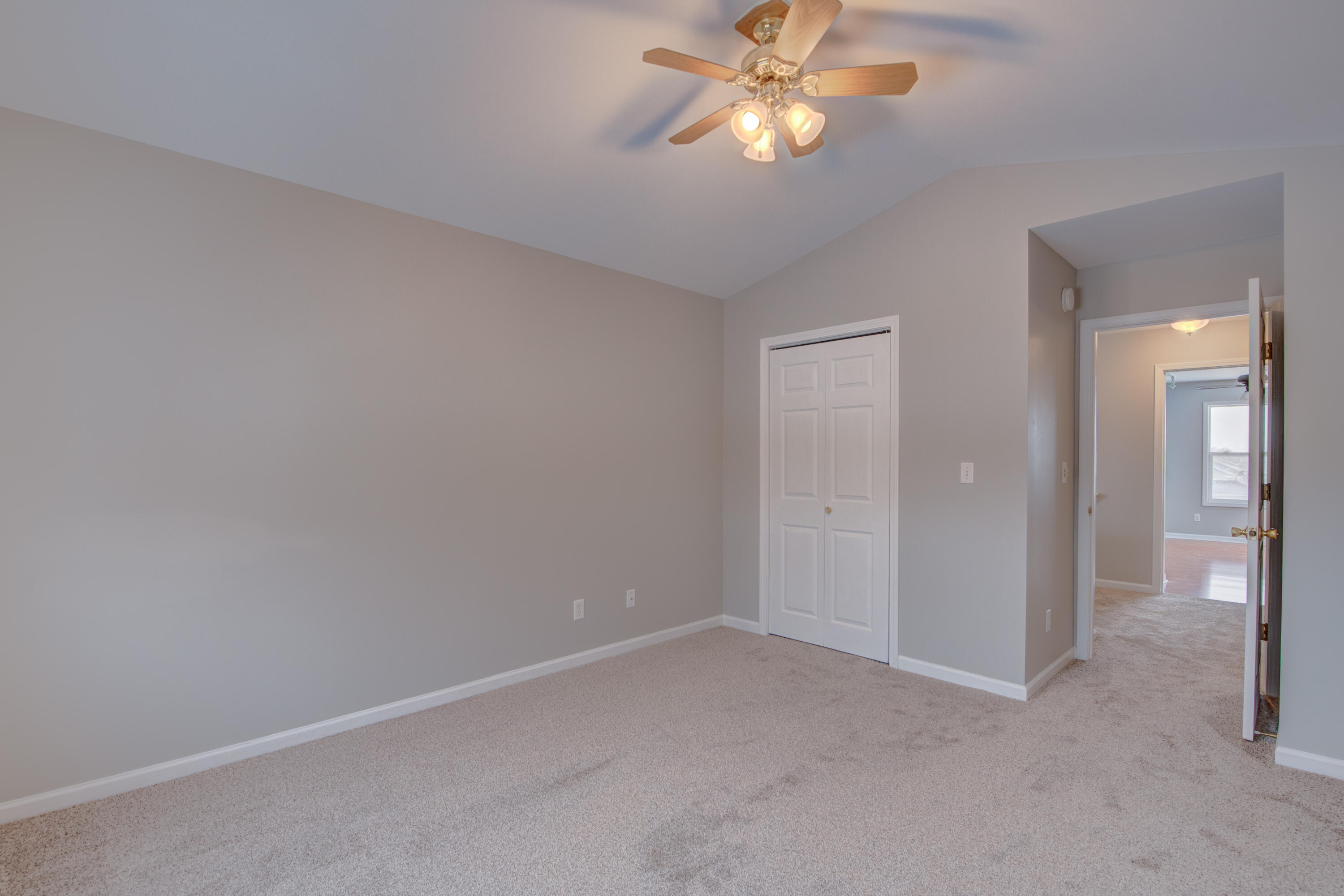 7736 East 108th Avenue, Unit C Crown Point, IN 46307 - Photo 25 of 28 an empty room with a chandelier fan and closet