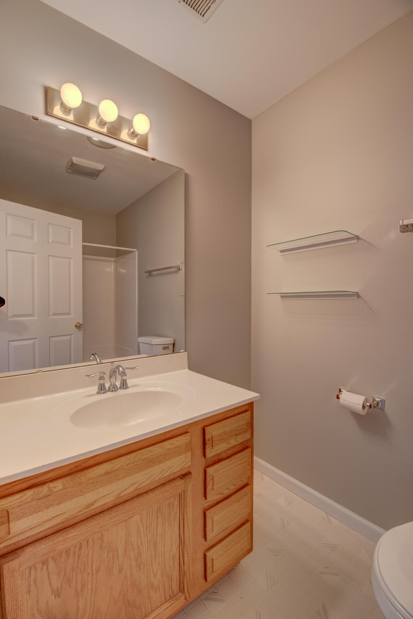 7736 East 108th Avenue, Unit C Crown Point, IN 46307 - Photo 26 of 28 a bathroom with a sink a toilet and mirror