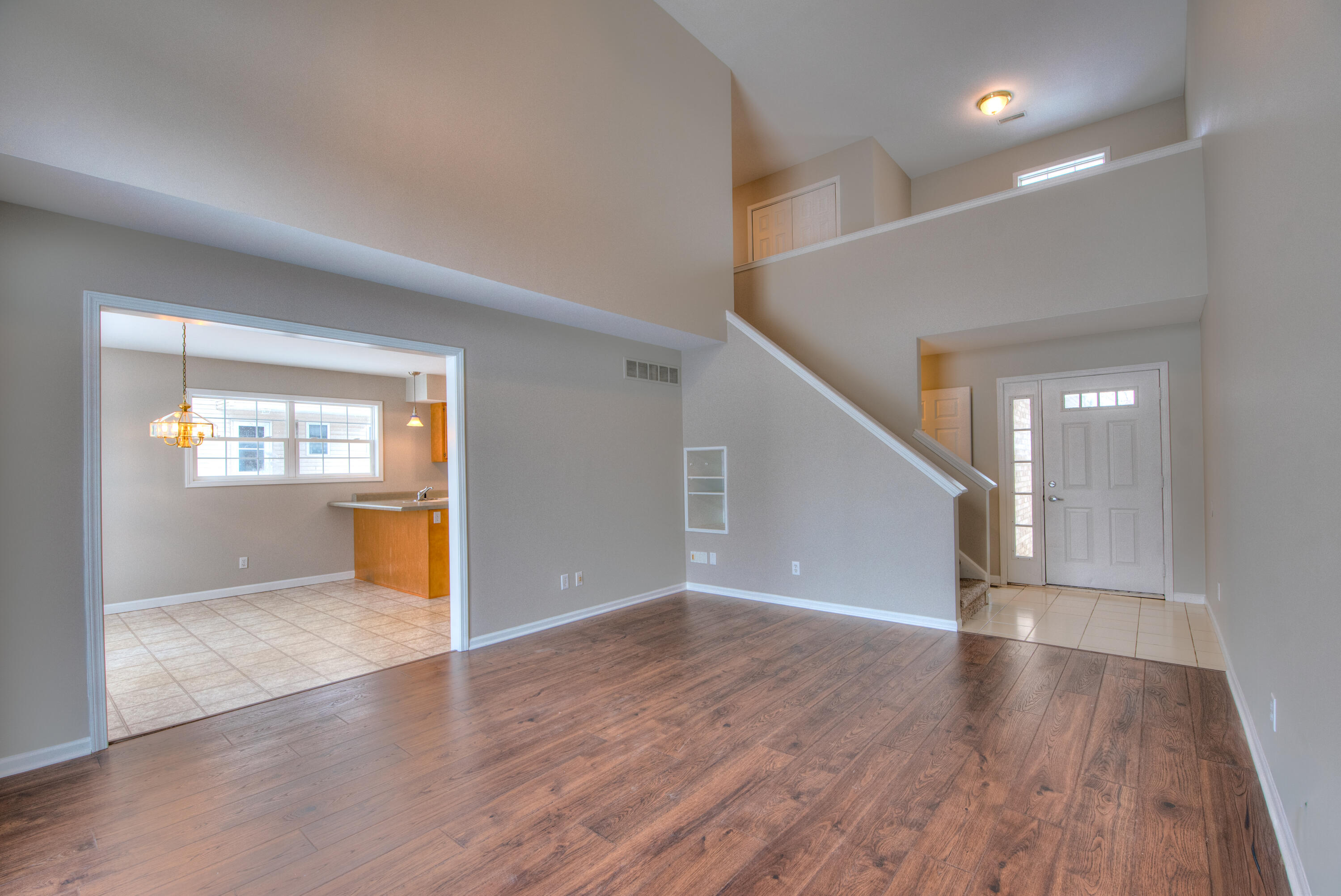 7736 East 108th Avenue, Unit C Crown Point, IN 46307 - Photo 7 of 28 wooden floor in an empty room with a window