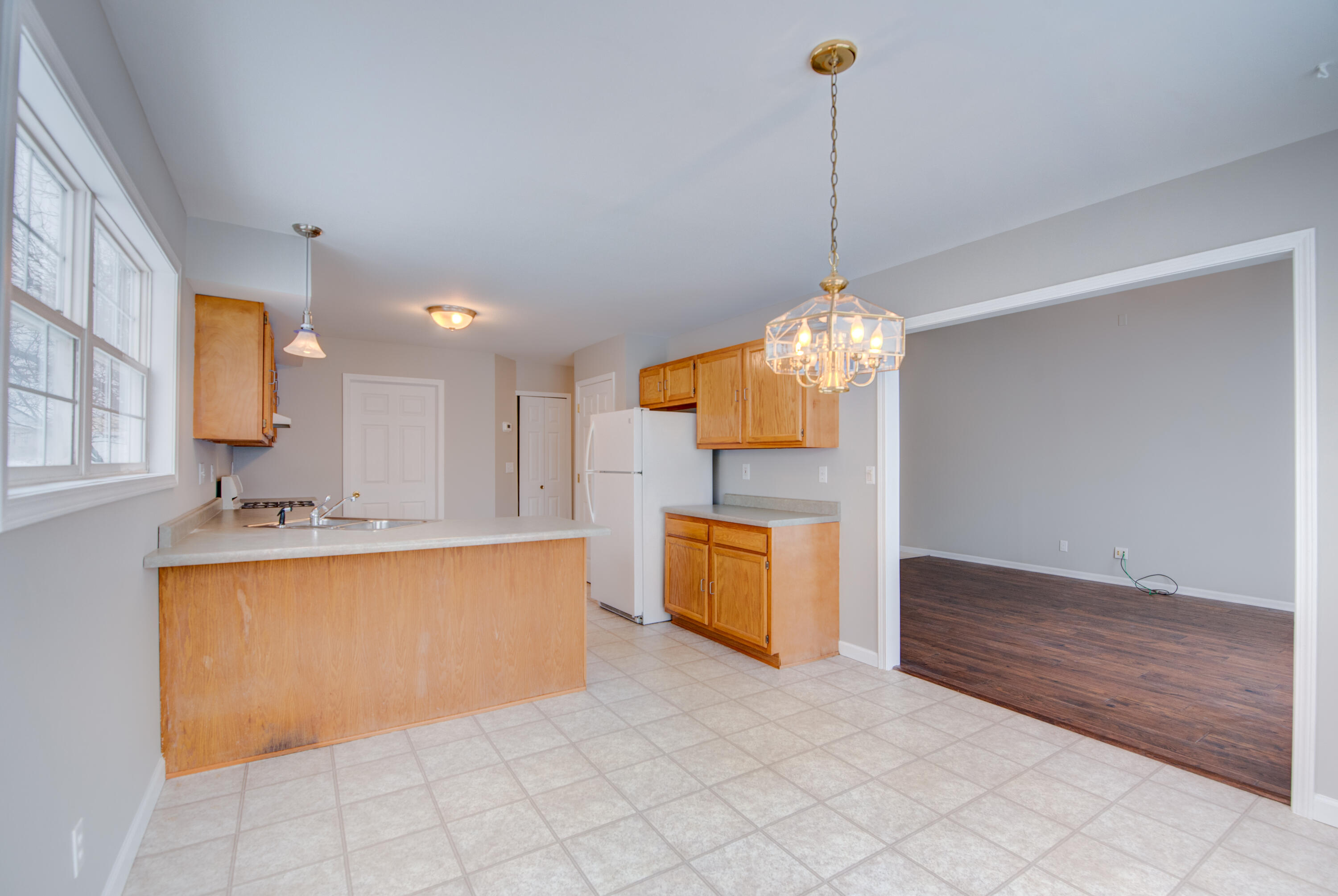 7736 East 108th Avenue, Unit C Crown Point, IN 46307 - Photo 8 of 28 a view of a kitchen with granite countertop cabinets and a wooden floor
