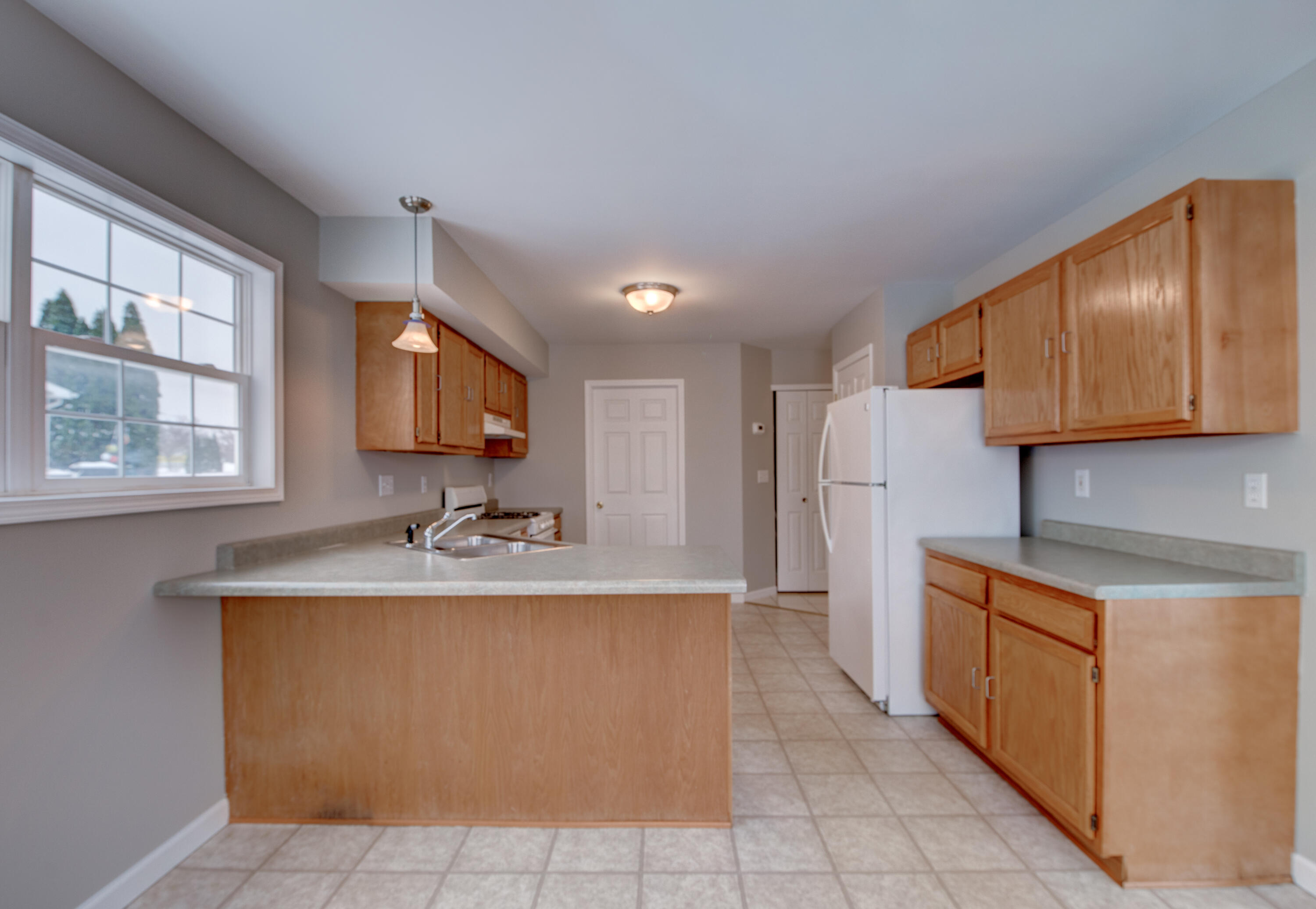 7736 East 108th Avenue, Unit C Crown Point, IN 46307 - Photo 9 of 28 a kitchen with stainless steel appliances granite countertop a sink stove and refrigerator