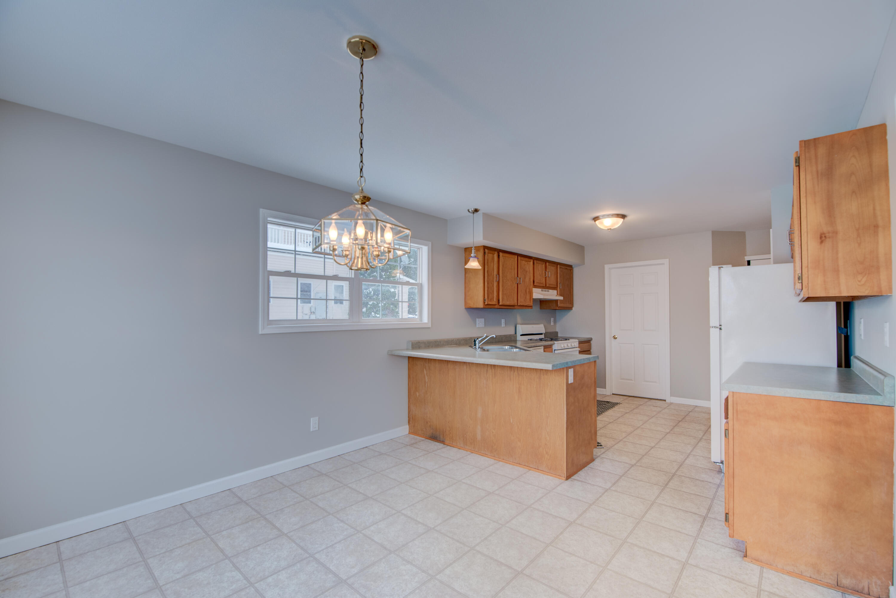 7736 East 108th Avenue, Unit C Crown Point, IN 46307 - Photo 10 of 28 a view of living room with granite countertop furniture and fireplace