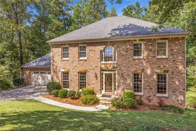 a aerial view of a house with a yard table and chairs