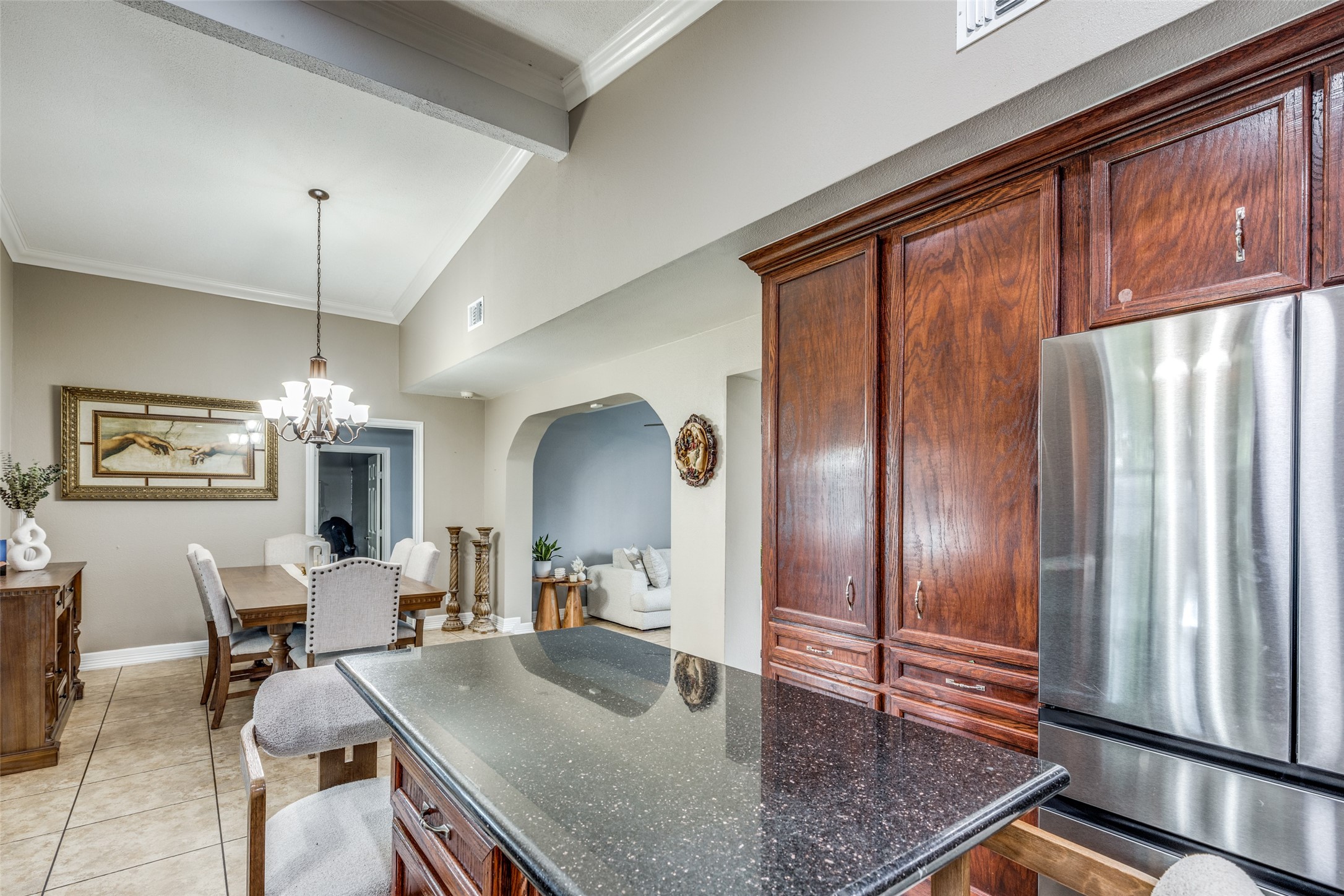7953 Hammerly Boulevard Houston, TX 77055 - Photo 10 of 24 a kitchen with stainless steel appliances granite countertop a refrigerator a stove a sink dishwasher a dining table and chairs with wooden floor