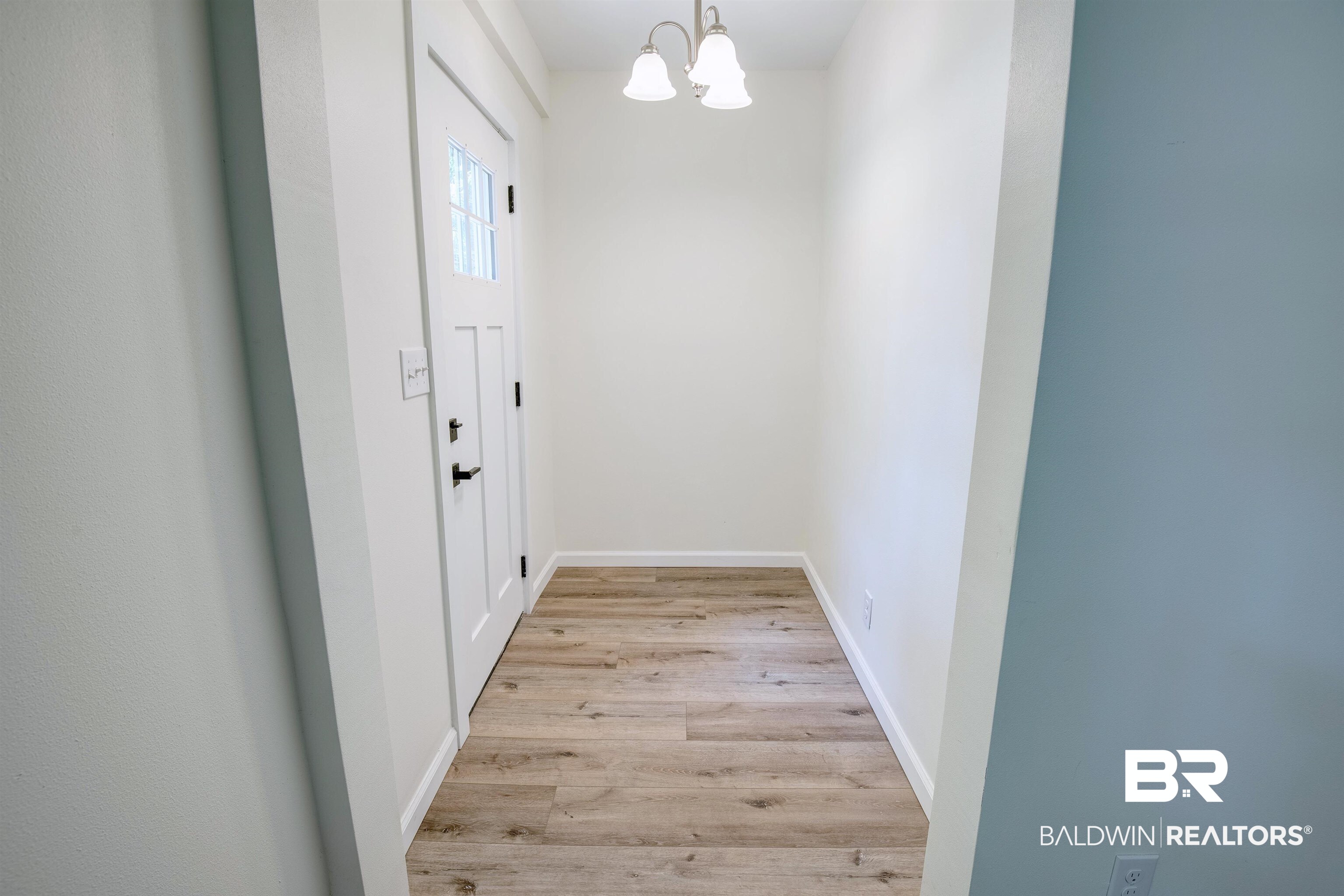 510 East Myrtle Avenue Foley, AL 36535 - Photo 4 of 22 Doorway to outside with a chandelier and light wood-type flooring