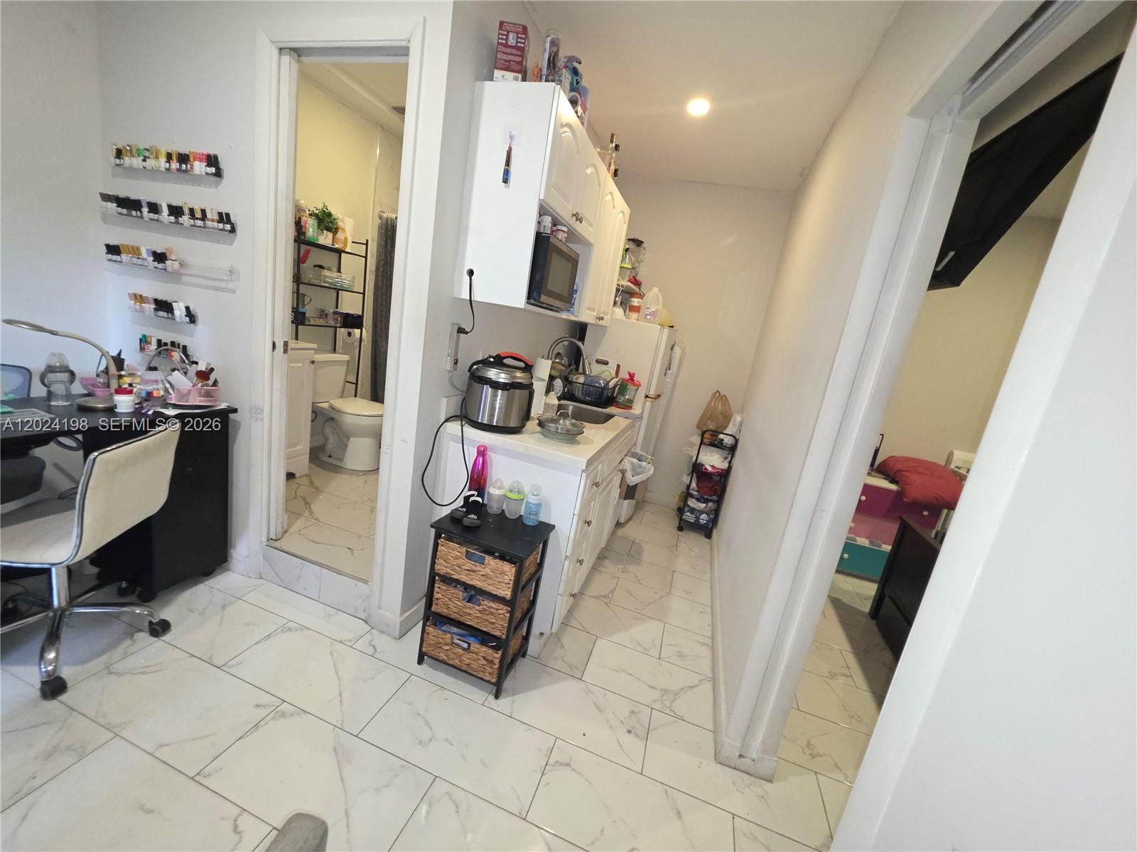 651 East 48th Street Hialeah, FL 33013 - Photo 47 of 52 a living room with furniture and a wooden floor