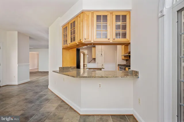 a bathroom with a granite countertop sink a mirror and shower