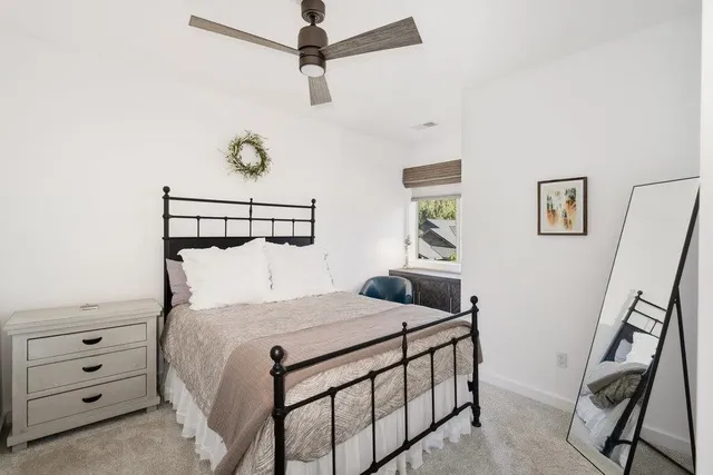 a bedroom with a bed next to a window