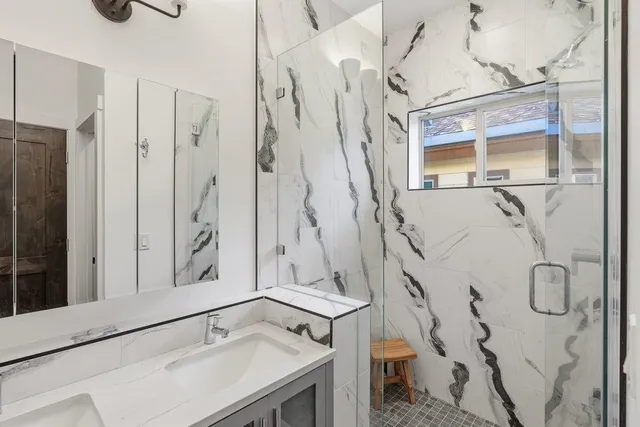 a bathroom with a shower and a sink