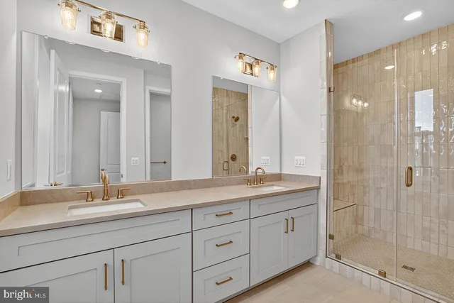 a bathroom with double sink and a mirror
