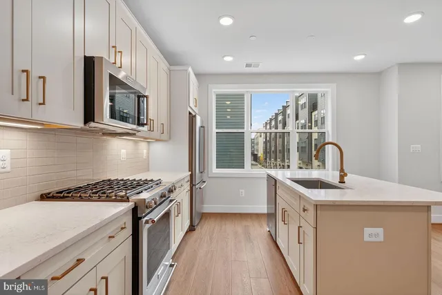 a kitchen that has a sink and a stove