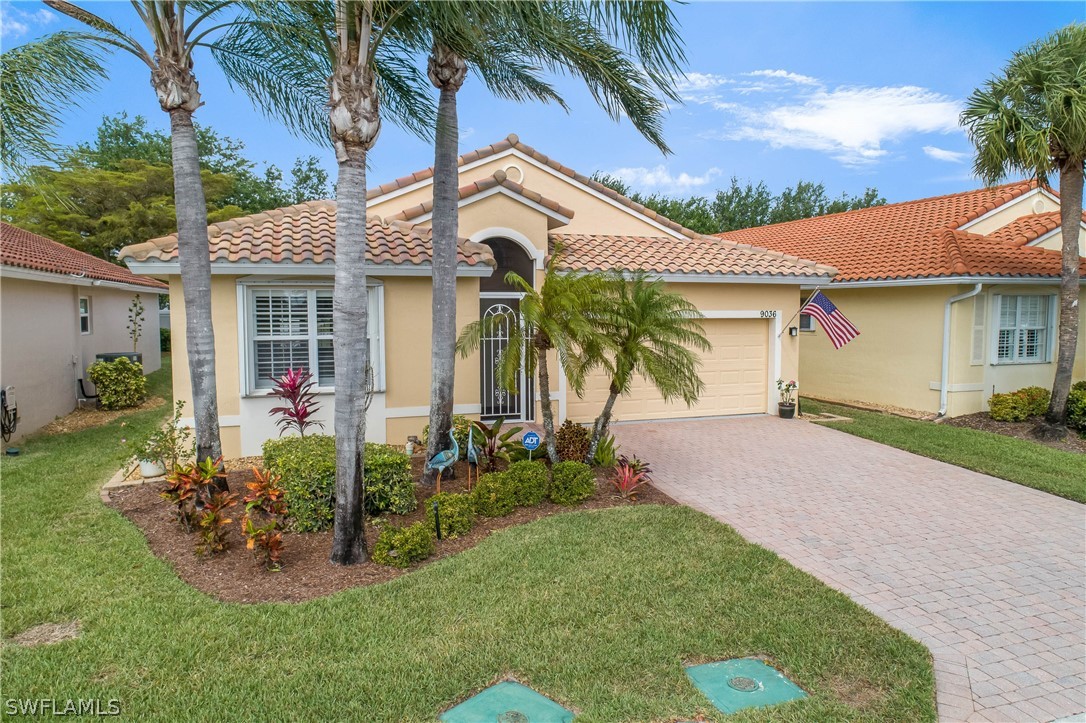 9036 Springview Loop Estero, FL 33928 - Photo 29 of 32 a view of a white house with a big yard and potted plants