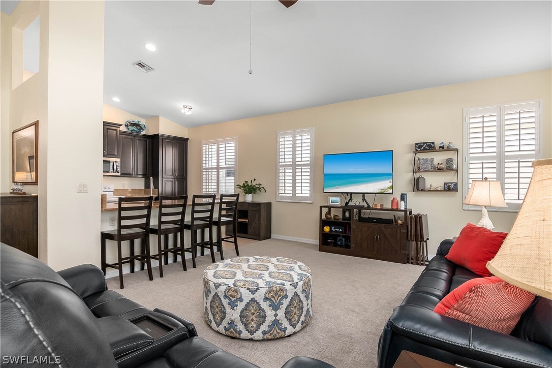9036 Springview Loop Estero, FL 33928 - Photo 7 of 32 a living room with furniture and a flat screen tv