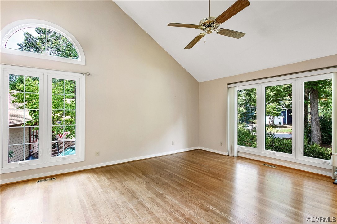 5826 Spinnaker Cove Road Midlothian, VA 23112 - Photo 17 of 38 Hardwood floored empty room with plenty of natural light, vaulted ceiling, a high ceiling, and ceiling fan