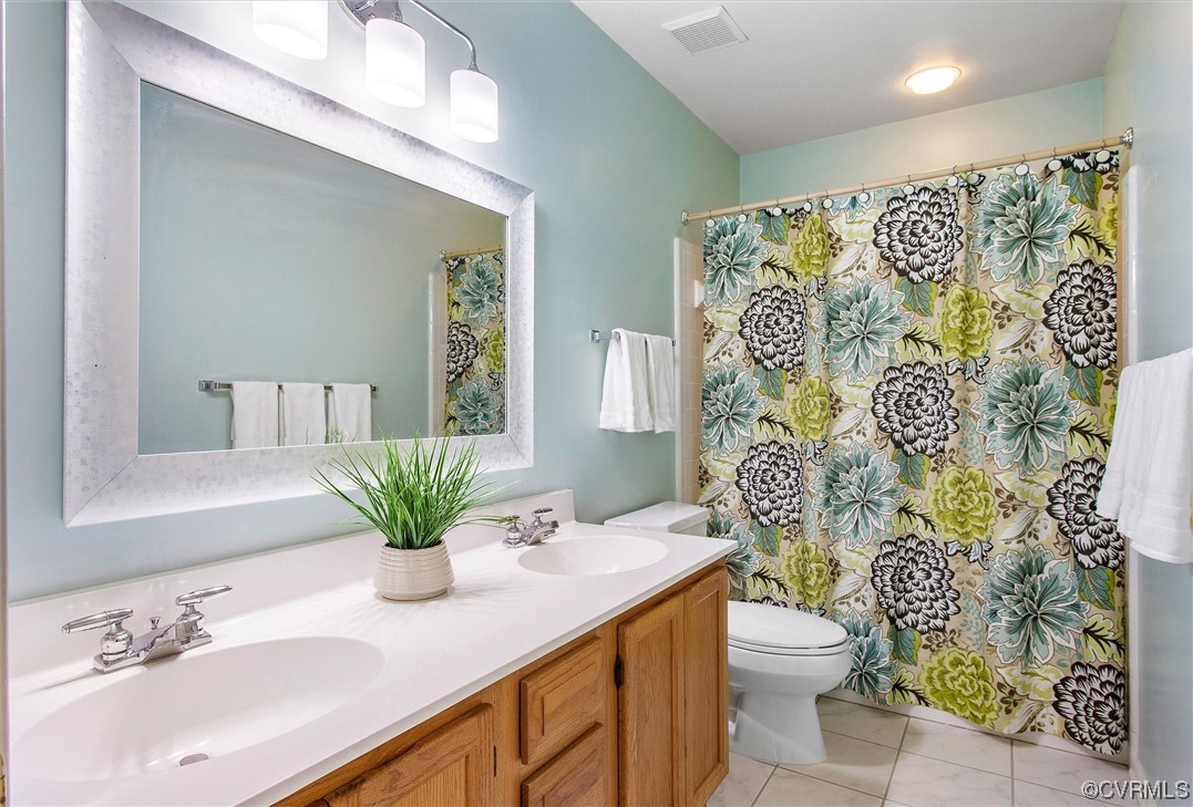 5826 Spinnaker Cove Road Midlothian, VA 23112 - Photo 29 of 38 Bathroom featuring double sink vanity, mirror, and light tile flooring