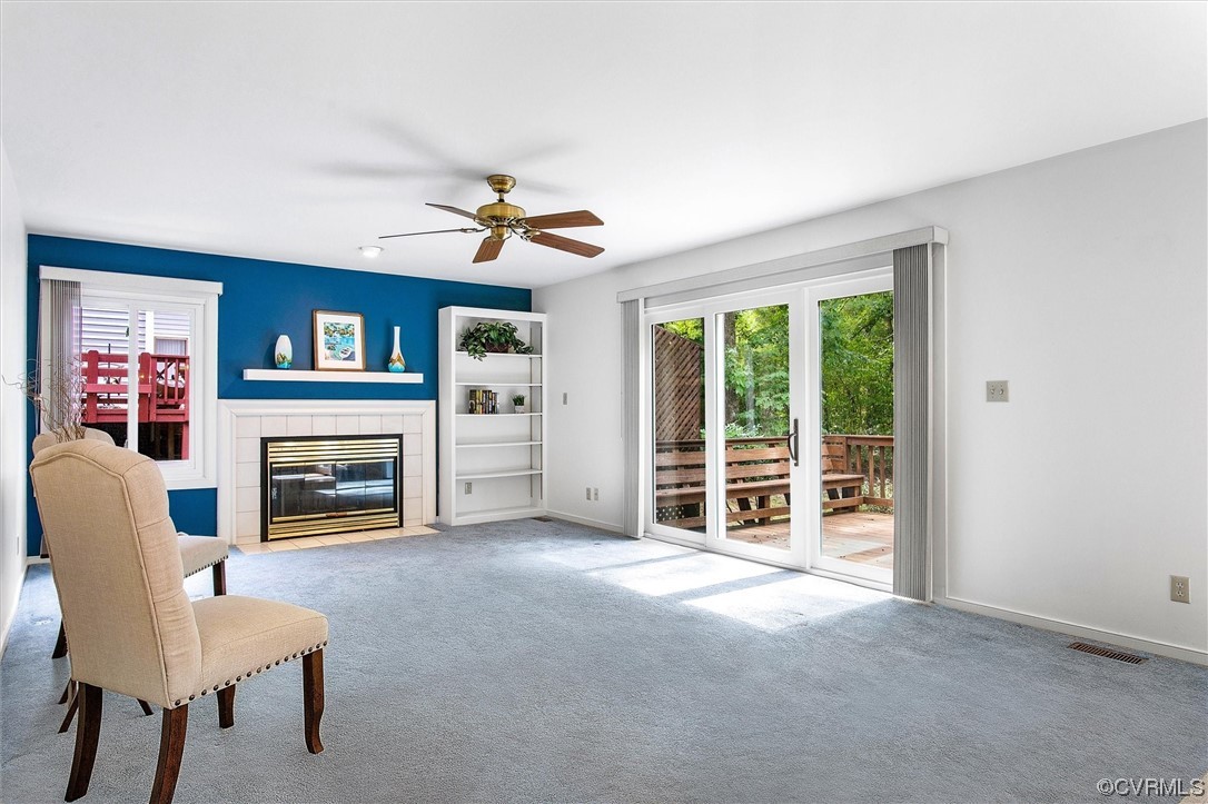 5826 Spinnaker Cove Road Midlothian, VA 23112 - Photo 8 of 38 Carpeted living room with a fireplace and ceiling fan
