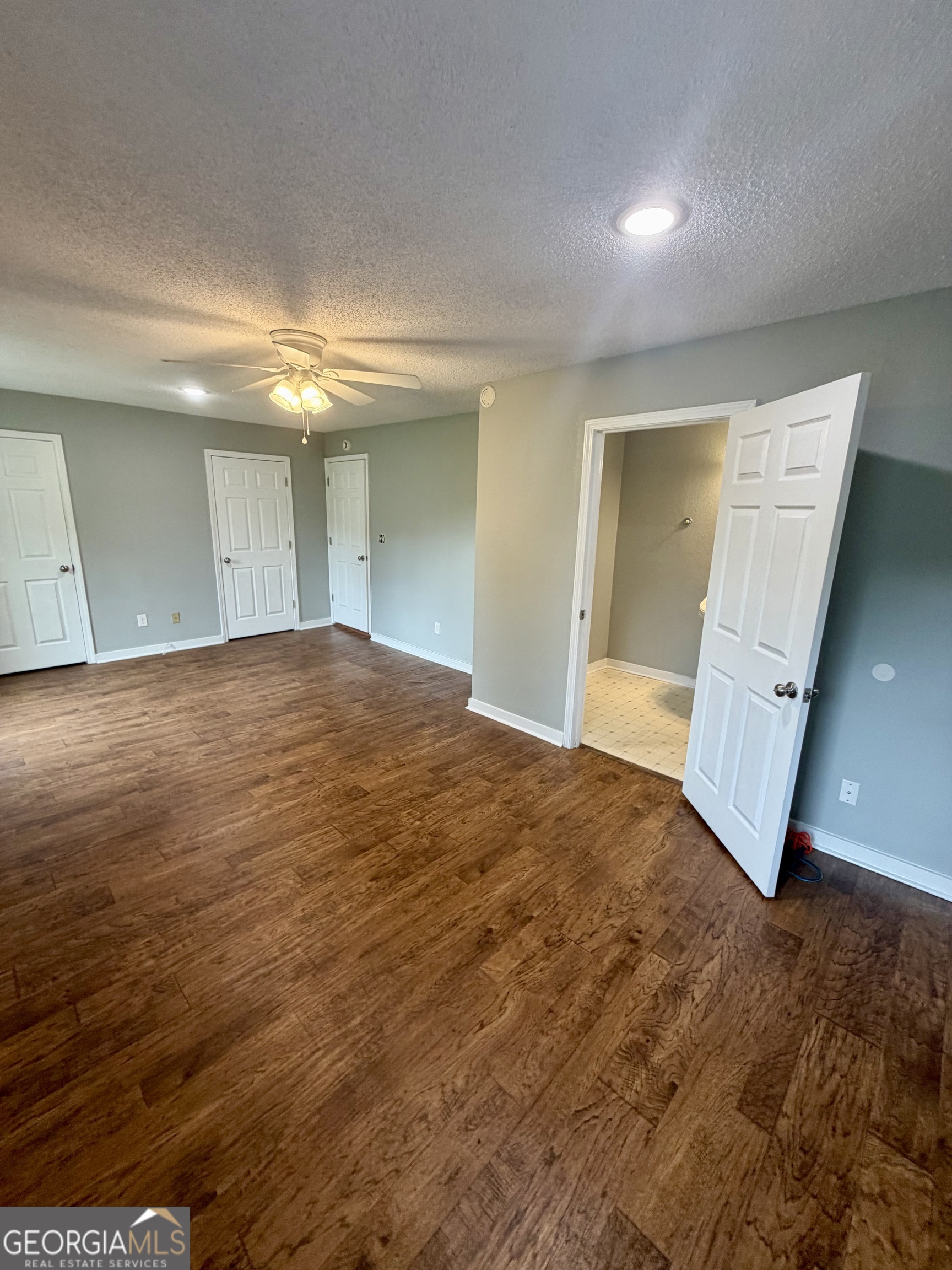 666 Woolfolk Street Macon, GA 31217 - Photo 40 of 60 an empty room with wooden floor and windows
