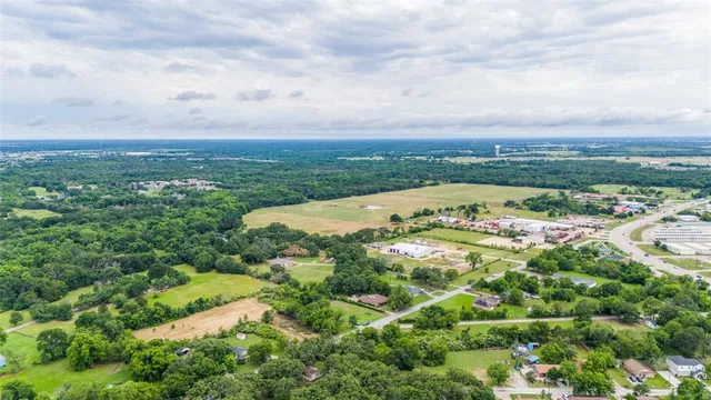 a view of a city with lush green forest