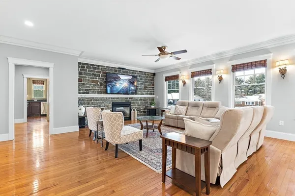 a living room with fireplace furniture and a wooden floor