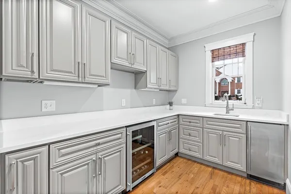 a kitchen with stainless steel appliances granite countertop a sink and dishwasher a stove with wooden floor