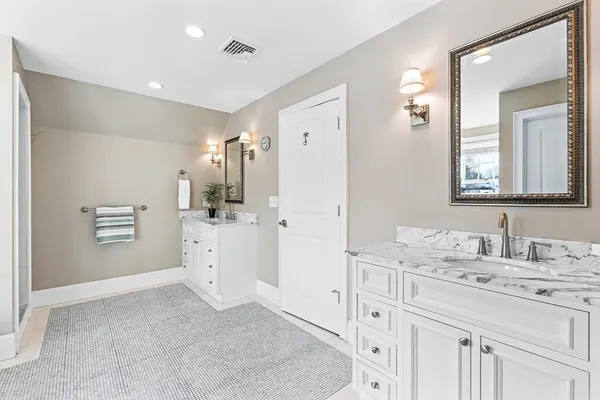a bathroom with a sink a vanity a mirror and a toilet