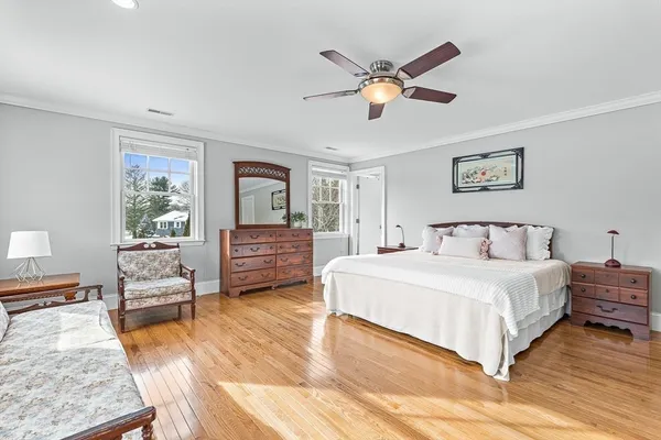 a spacious bedroom with a bed a couch and a window