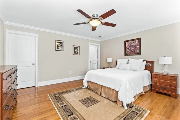 a spacious bedroom with a bed and a window
