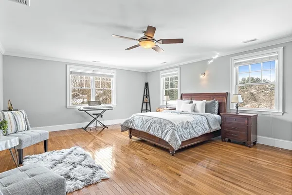 a bedroom with a large bed and a window