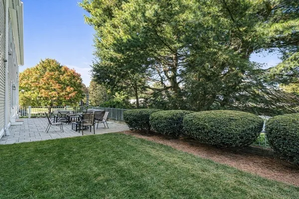 a view of a chairs and table in the back yard