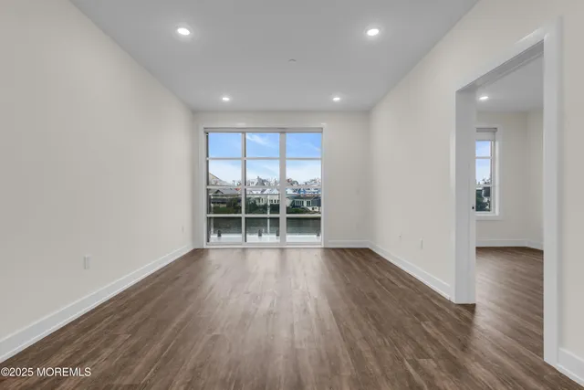 a view of wooden floor and windows in a room