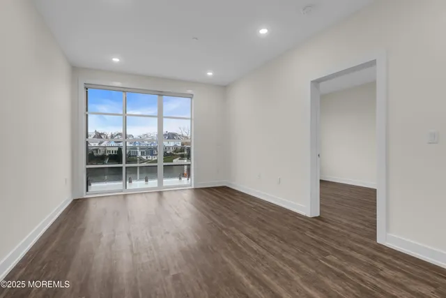 a view of kitchen and hall with wooden floor