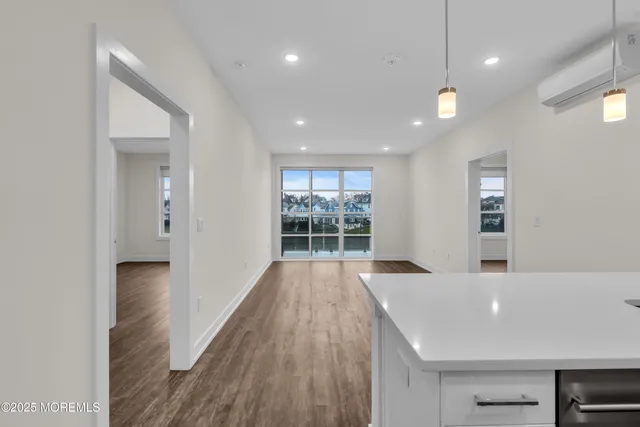 a kitchen with stainless steel appliances granite countertop a sink a stove and a wooden floors