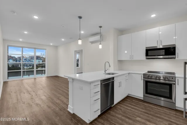a kitchen with stainless steel appliances a stove a sink a stove and cabinets