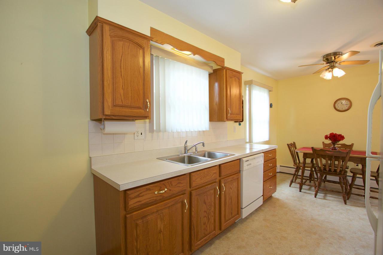 2307 Mills Road Fallston, MD 21047 - Photo 12 of 30 a kitchen with a sink cabinets and dining table